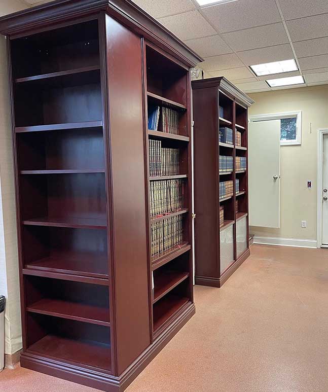 A room with two bookcases and a door.