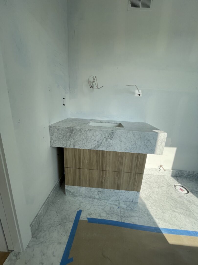 A bathroom is being remodeled with a marble counter top.