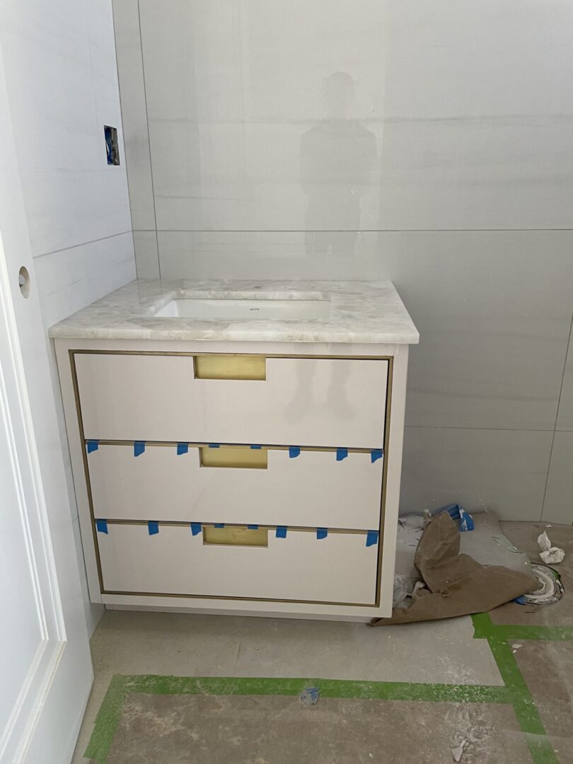 A wooden cupboard with basin under construction