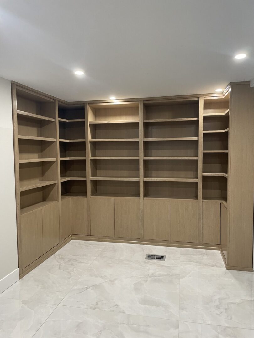 A room with empty wooden book shelves